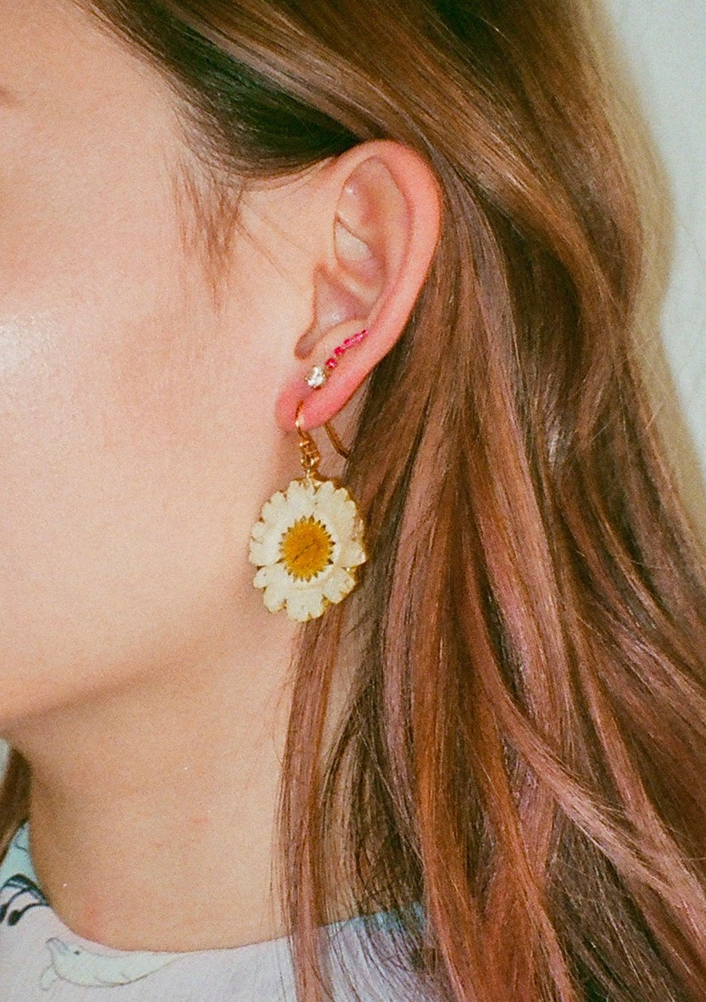 Resin coated miniature white Daisy with yellow center on French Hook Earring