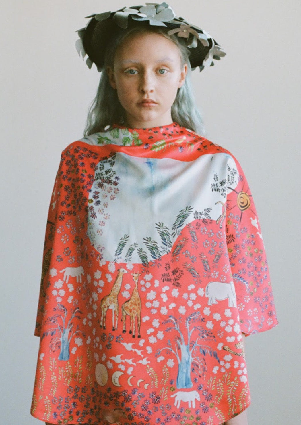 Printed in Olivia Cheng's Fever Dream, a tailor-made, satin draped mid-sleeve top. Keyhole back.