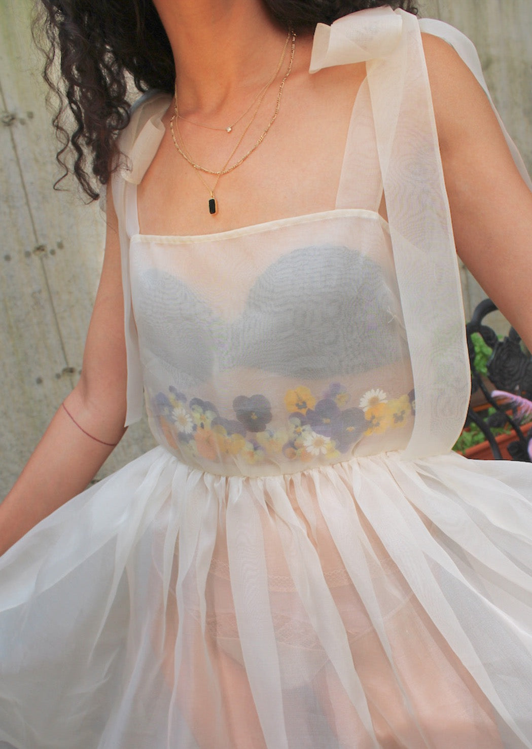 for each dress we use over fifty real flowers, pressed and sealed into custom-cut arrangements before being inserted between layers of dreamy silk organza. Exaggerated self-tie straps and universally flattering silhouette. Invisible side zip. Each one unique. Made in New York.