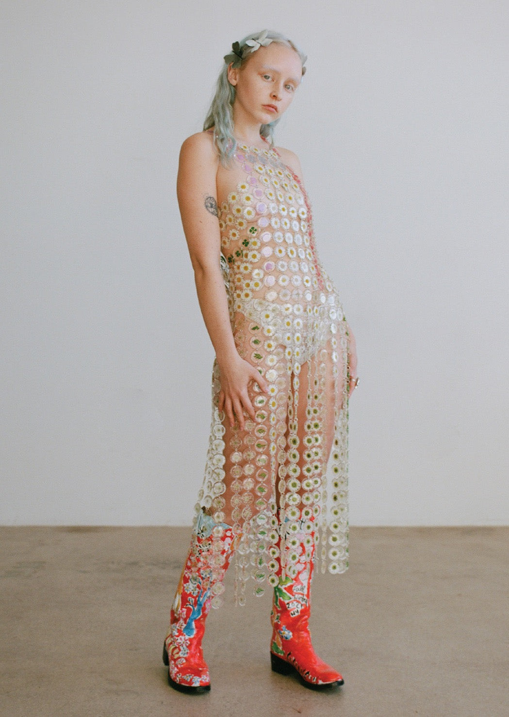 Our floral chainmaille is a distinctive, first-of-its-kind technique where hundreds of preserved botanicals are intricately assembled-- this top is crafted from over six hundred flowers. Antiqued silver toggle side closure for easy on/off.