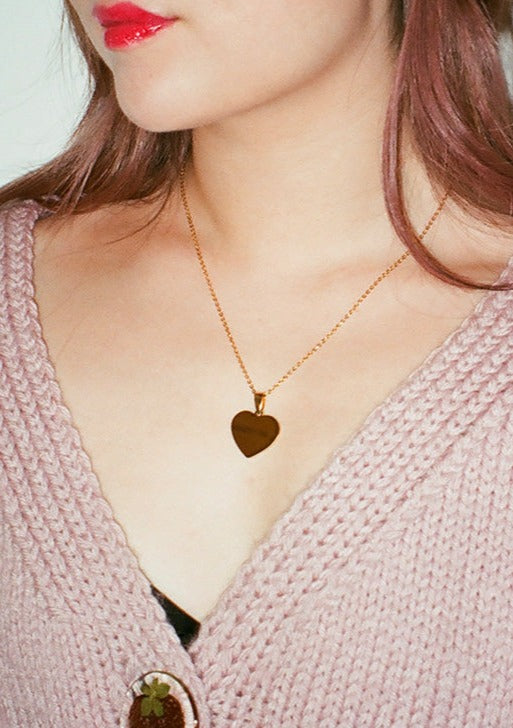Gold heart pendant necklace featuring "Forget You" engraving on one side and "Dauphinette" on the other