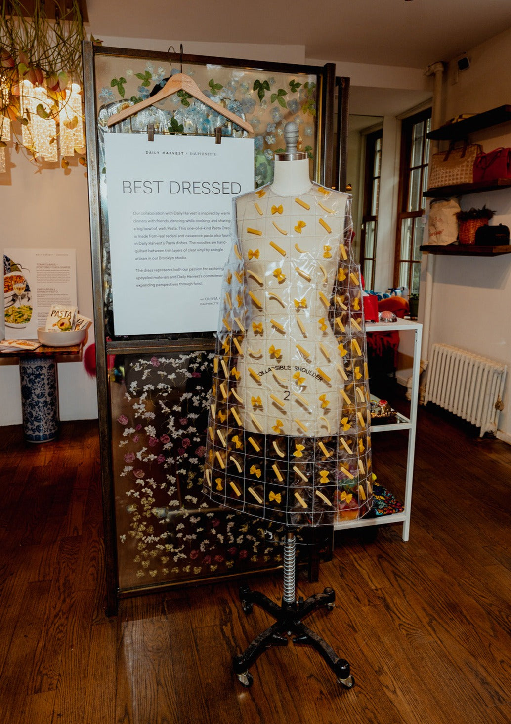 The museum-worthy Pasta Dress features over 300 pieces of real pasta quilted between clear vinyl. Keyhole back.