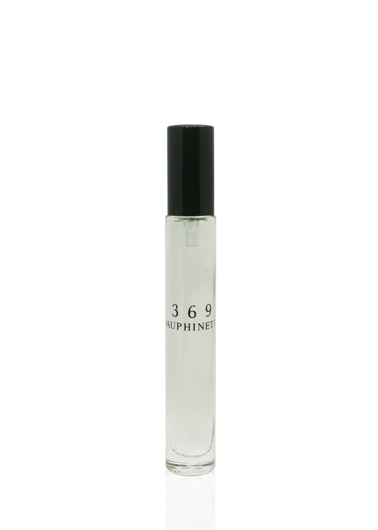 A travel sized clear glass cylindrical bottle of Dauphinette's signature perfume labeled "369 Dauphinette" with a  black spray top.