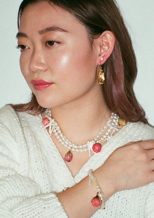 Rosebud charm on freshwater pearl bracelet.