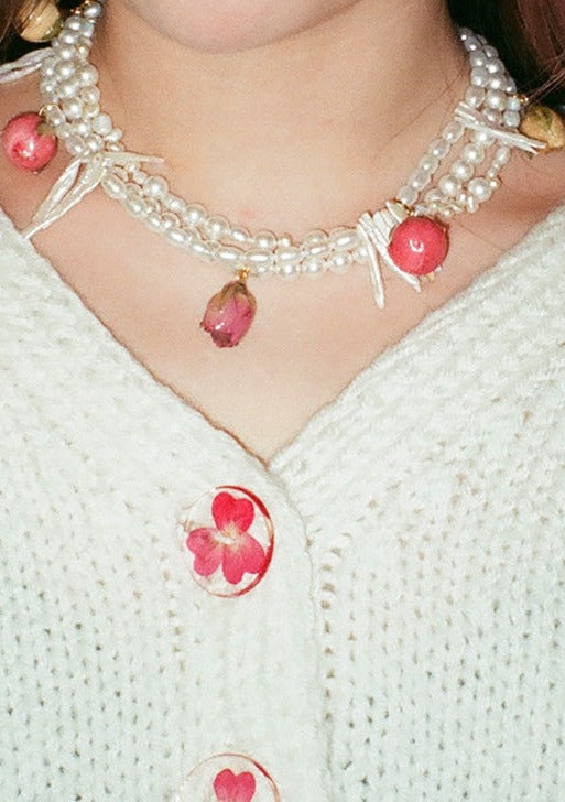Tripled stranded freshwater and glass pearl necklace with mixed preserved rosebuds and gold clasp.