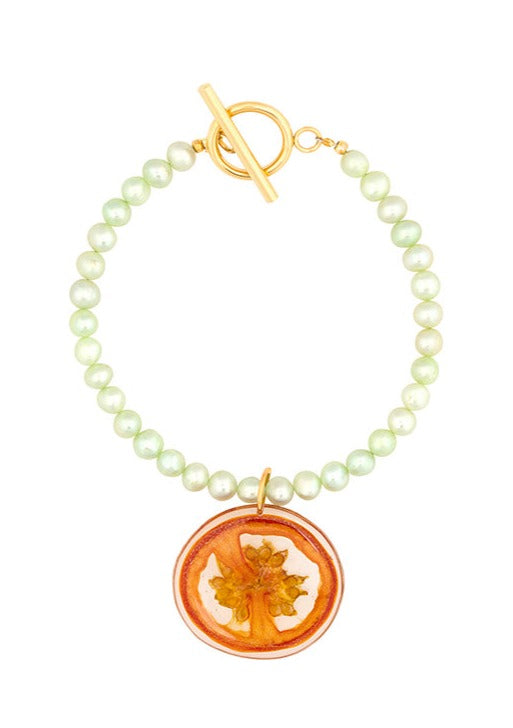 Avocado green cultured freshwater pearl bracelet with tomato pendant