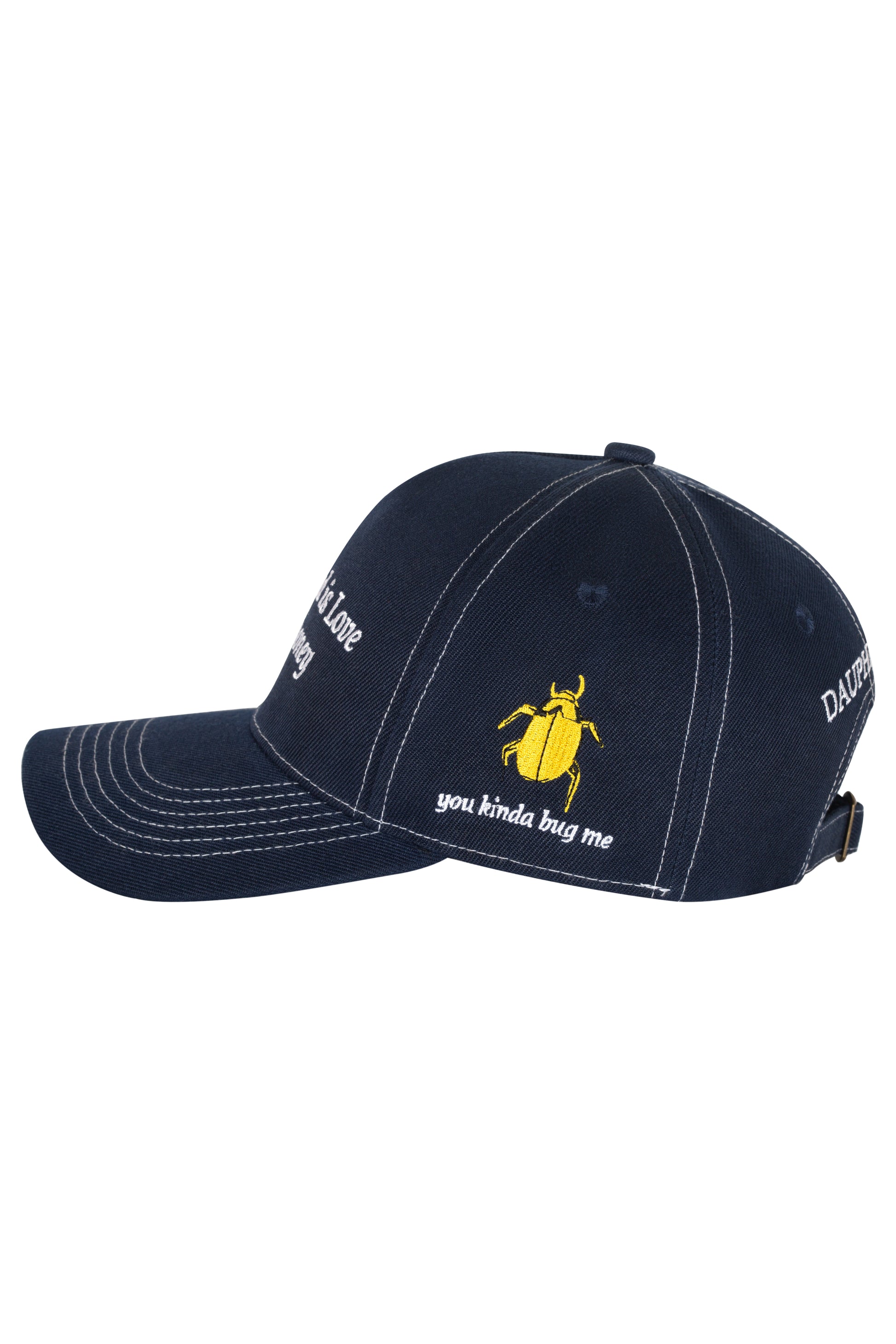 Side profile of navy blue cap with yellow embroidered beetle and the words "You kinda bug me" embroidered in white thread.