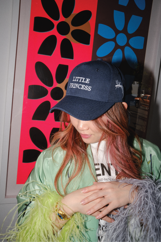 Navy blue cap with the words "Little Princess" embroidered on it in white thread.