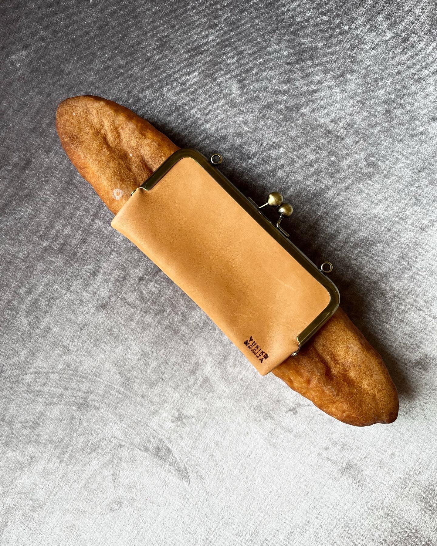 Baguette bag! Crafted from real, surplus bread-- baked, hollowed, and reimagined into a delightful bag in Japan. Coated in an anti-bacterial and anti-fungal, eco-friendly resin.