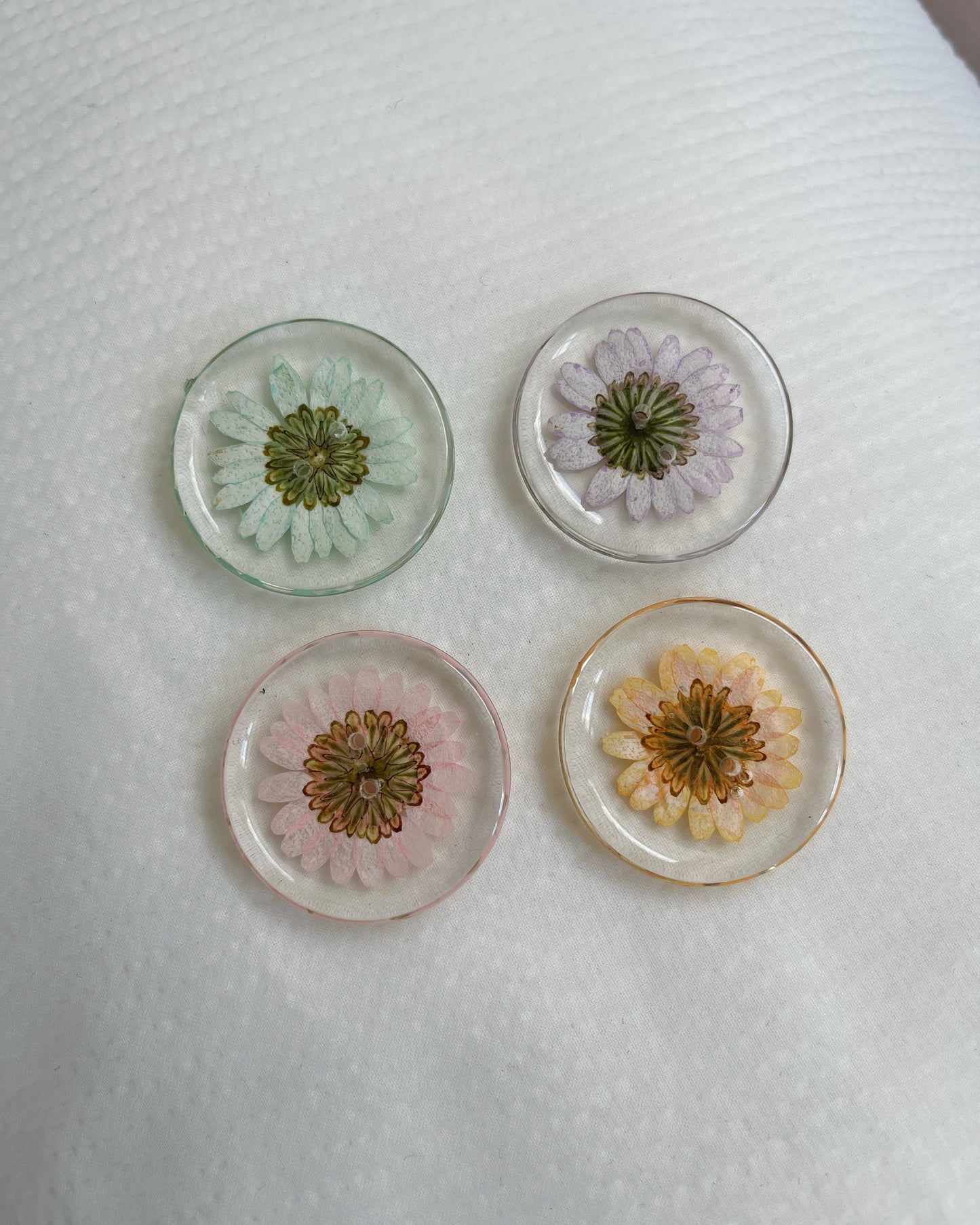 4 round neon daisy-filled buttons