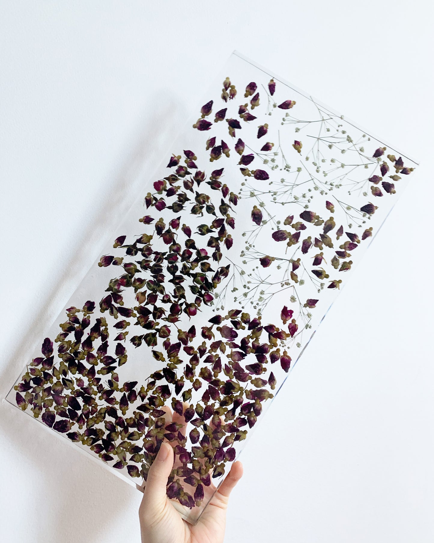 Hundreds of rosebuds sit suspended between sprigs of baby's breath. A durable-yet-whimsical addition to your home decor. Serve cocktails, use as a vanity tray, or simply display as an incredible objet d'art.
