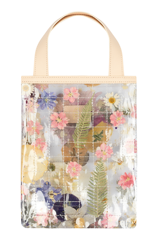 Clear quilted tote bag with dried leaves and flowers and cream straps.