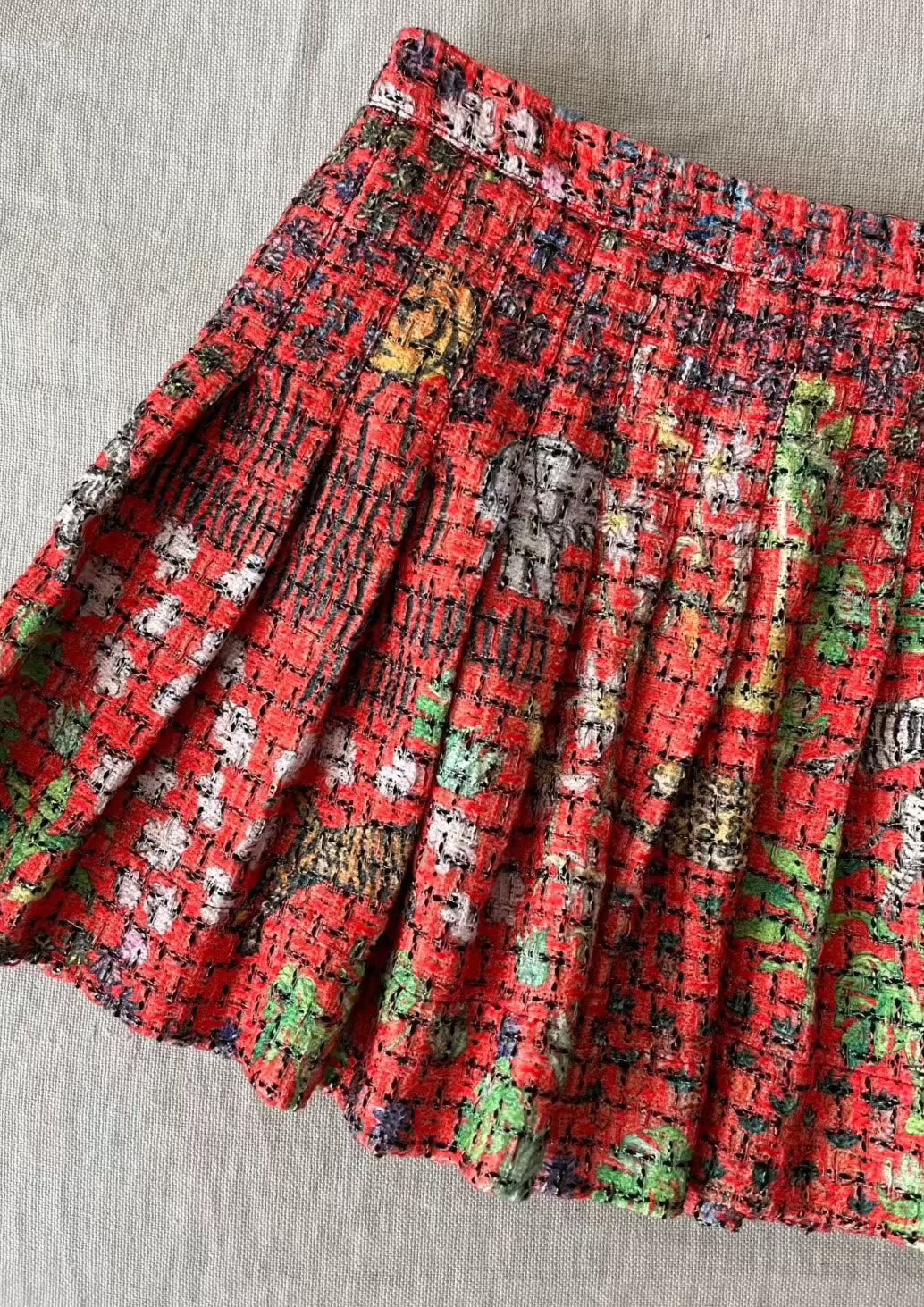Tweed pleated mini skirt in signature red Fever Dream print, hand-illustrated by designer Olivia Cheng.