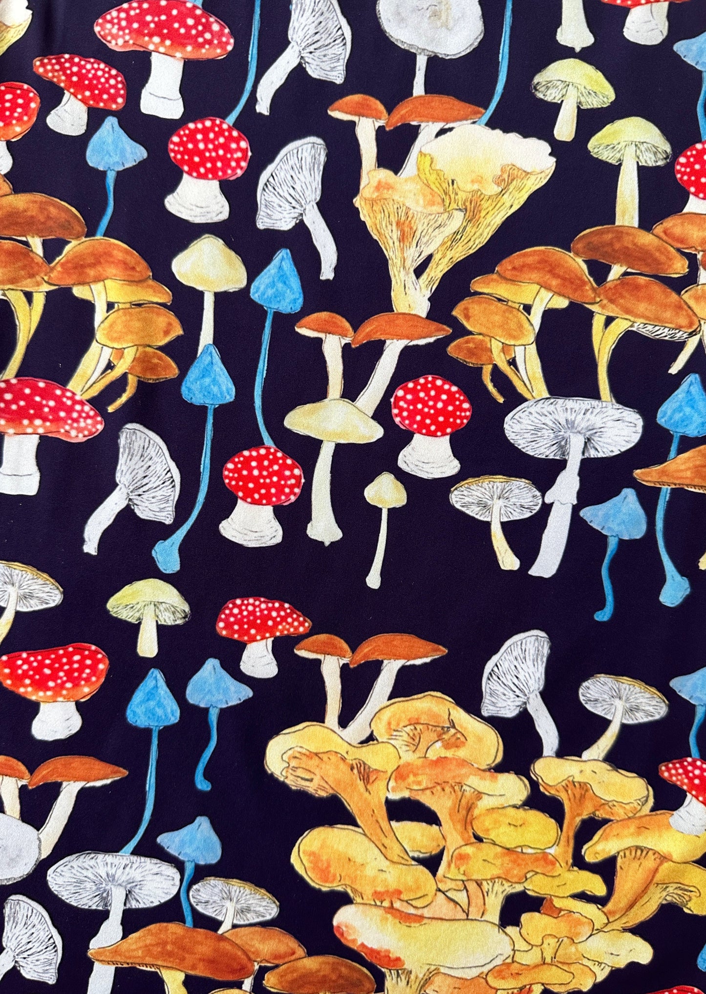The platonically ideal high-cut tank top in our never-before-seen Death Cap for Cutie red, white, yellow, and blue mushroom printed navy blue jersey. Hand-illustrated print by designer Olivia Cheng, made with surplus fabric found at our studio.