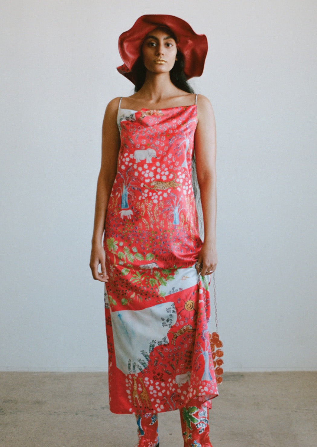 Our fever dream print is a whimsical amalgamation of friendly tigers, leisurely leopards, and pink popcorn flowers, seen here in a draped long slip dress.