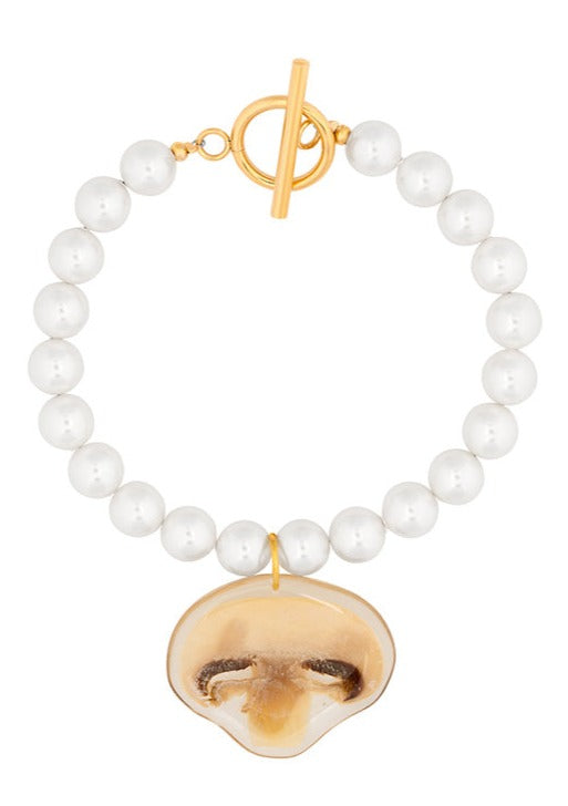 Swarovski glass pearl bracelet with mushroom charm and gold clasp.