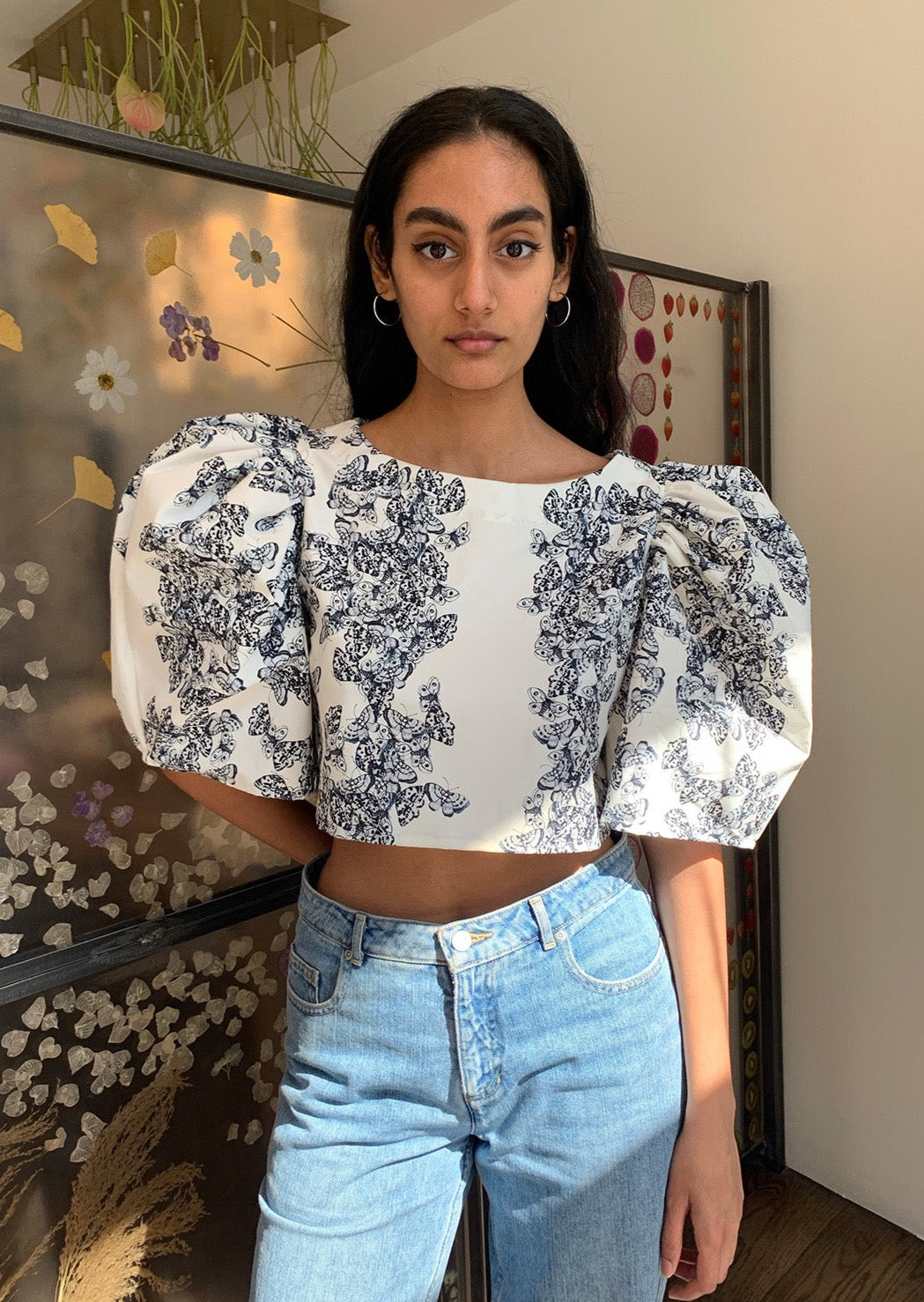 Cropped shirt with bateau neckline and voluminous mid-length bishop sleeves. Slips on. Constructed from smooth deadstock twill printed with our Scrapbook Floral print.