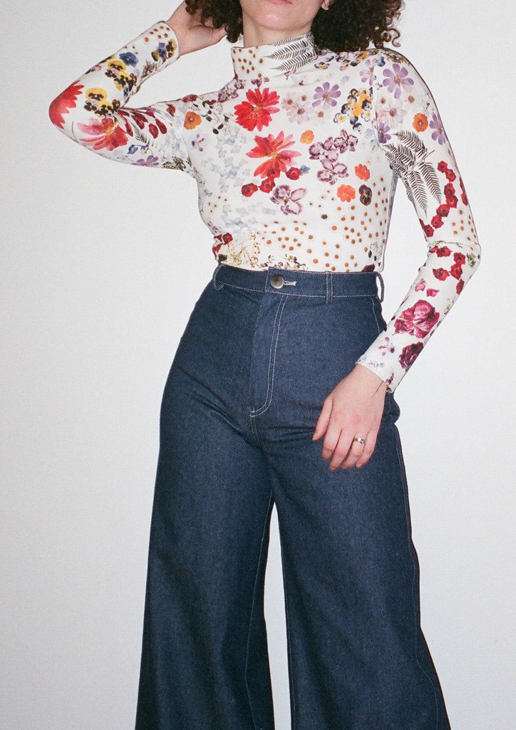 Perfect french-cut turtleneck in our Potpourri print, featuring scanned florals from our NYC studio. Made from a recycled polyester blend that is both anti-bacterial and water-resistant-- meaning this top can also be worn as a swim top or rash guard.