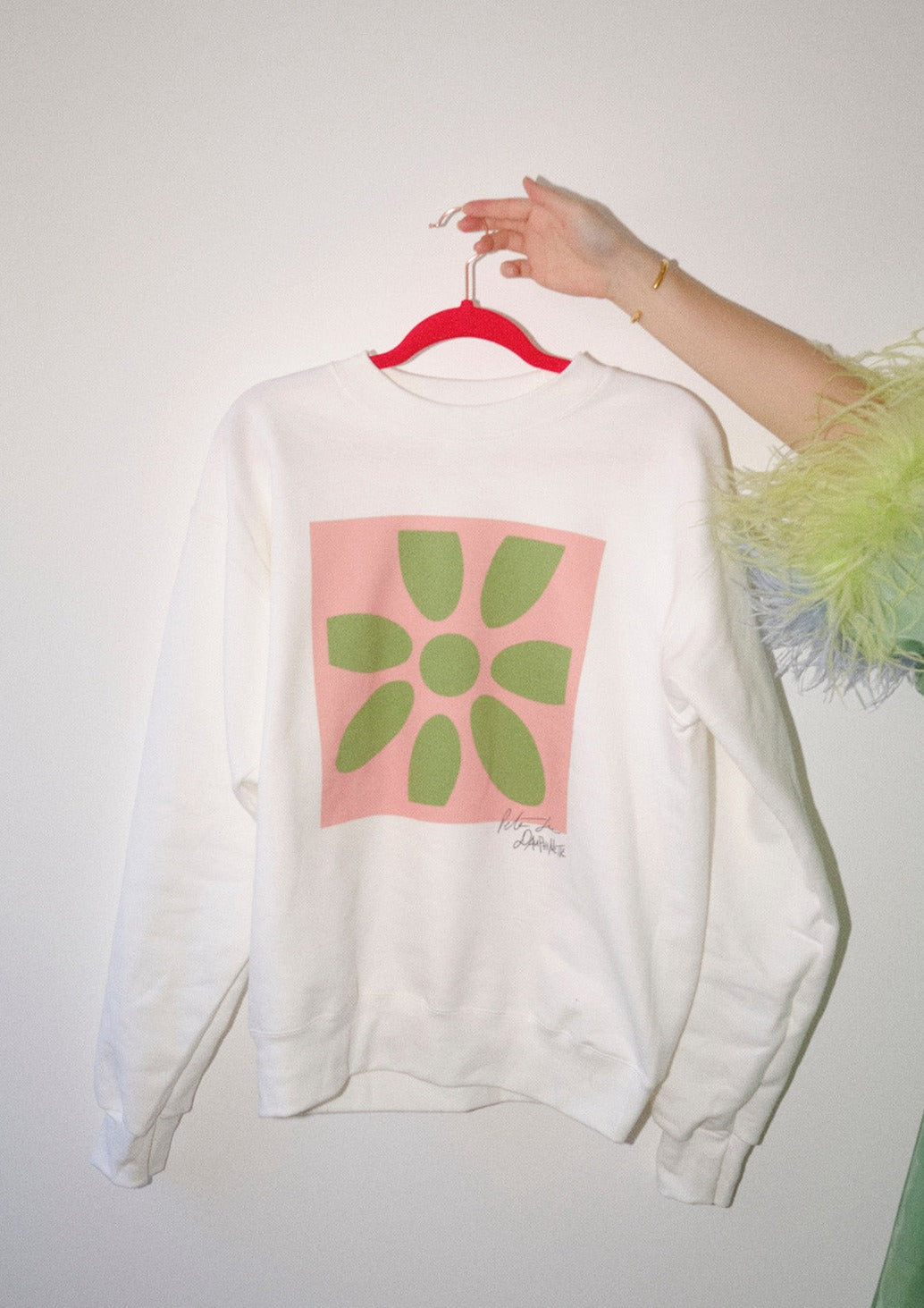 White pullover with Peter Gee's iconic pink and green flower screen print