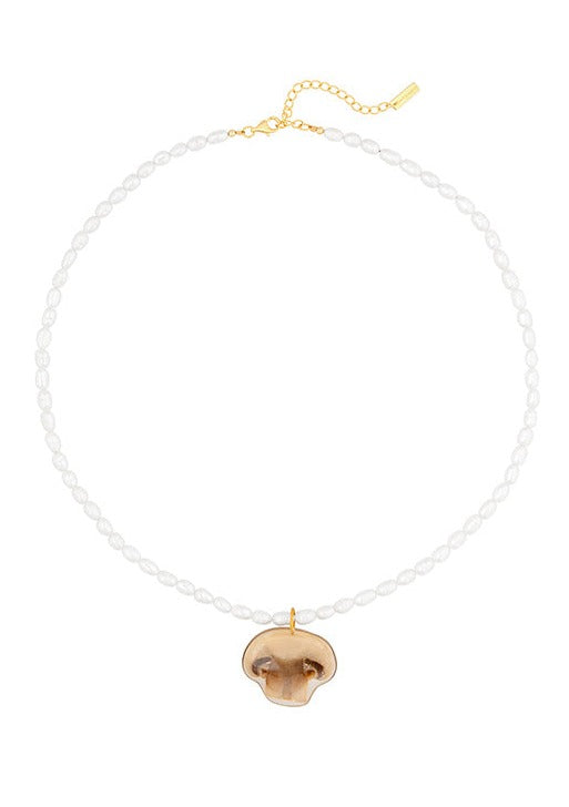 Resin coated slice of mushroom on beaded pearl necklace with gold clasp.