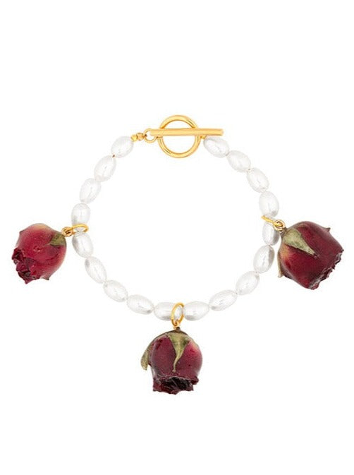 Ivory rice pearl bracelet with triptych of vampire rosebuds.