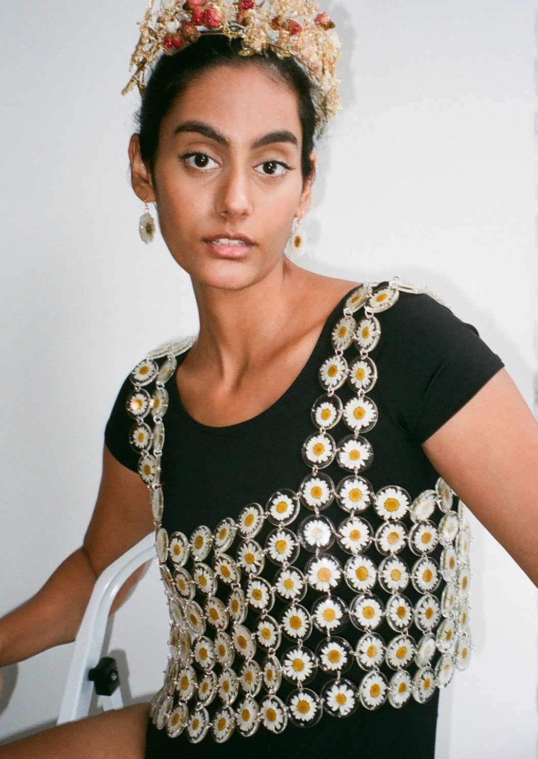 Our floral chainmaille is a distinctive technique where hundreds of preserved botanicals are intricately assembled-- this top is crafted from over two hundred daisy flowers. Relaxed fit, antiqued silver toggle side closure for easy on/off. 