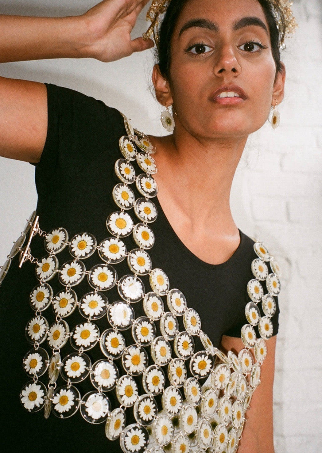 Our floral chainmaille is a distinctive technique where hundreds of preserved botanicals are intricately assembled-- this top is crafted from over two hundred daisy flowers. Relaxed fit, antiqued silver toggle side closure for easy on/off. 