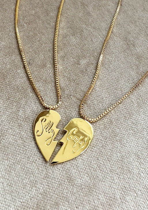 Gold Happy Hearts Necklace Pair with the words Silly and Goofy on each heart half on thin gold chain.