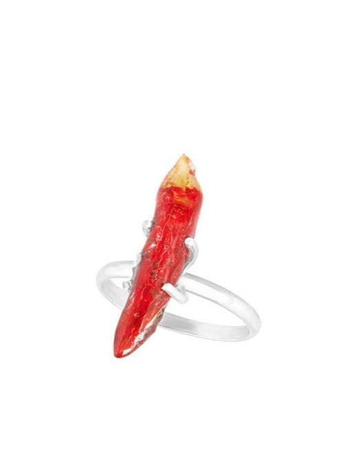 Chili preserved in resin on a silver ring band.