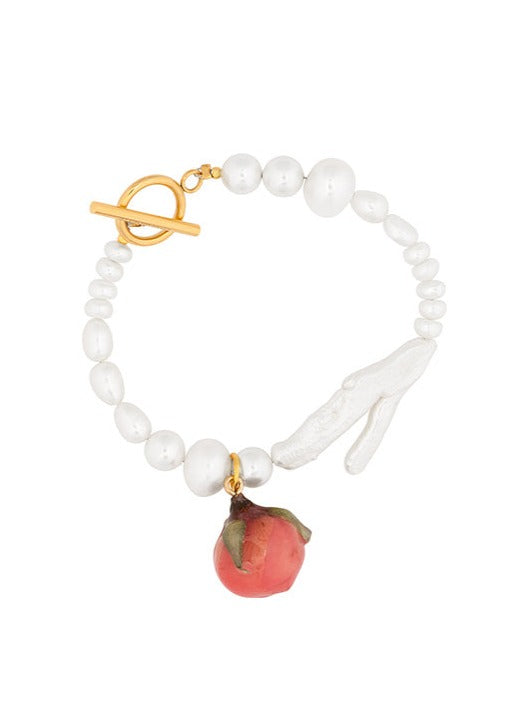 Rosebud charm on freshwater pearl bracelet.