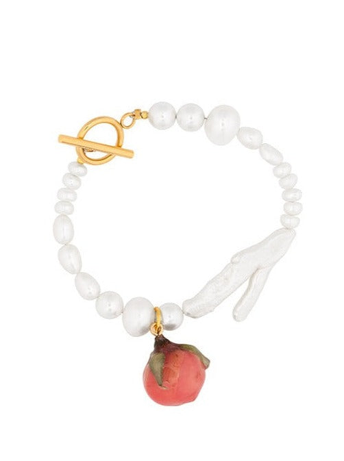 Rosebud charm on freshwater pearl bracelet.