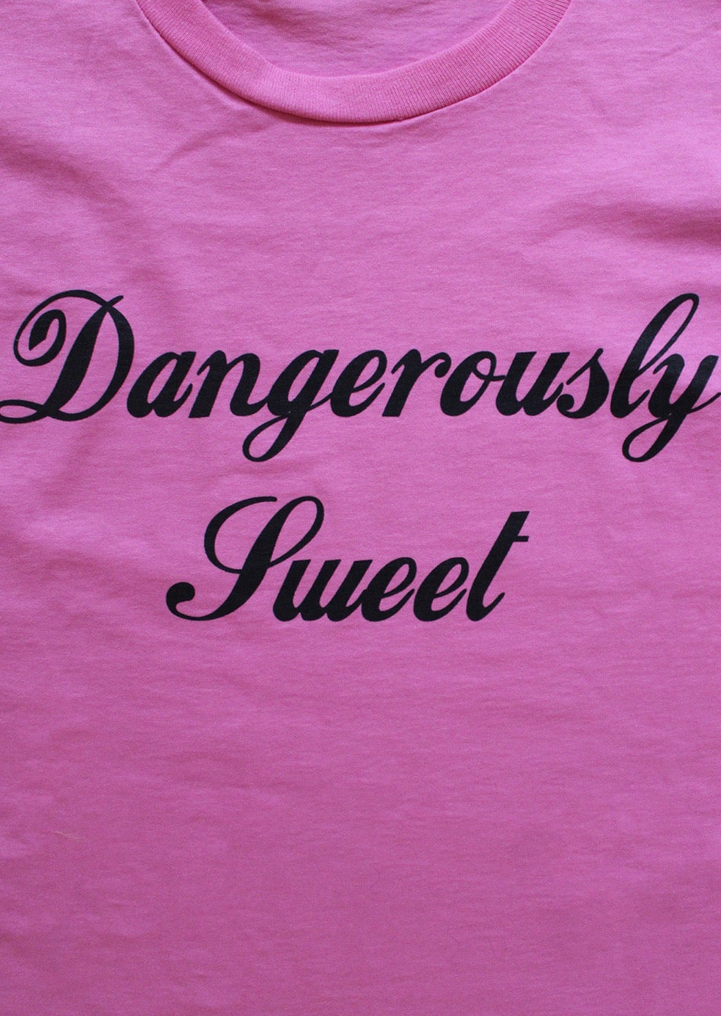 Printed cotton tshirt with "Dangerously Sweet" graphic in vintage cola font.