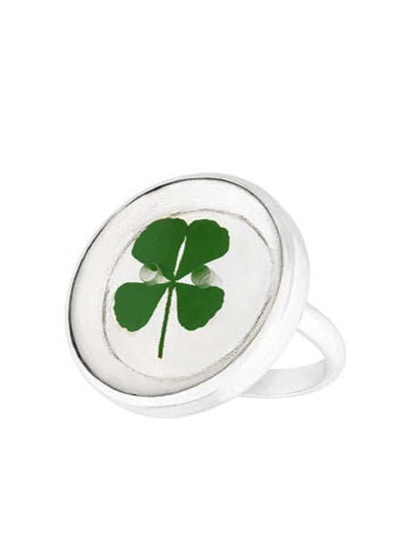 Four leaf clover in round button shaped resin on silver ring band.