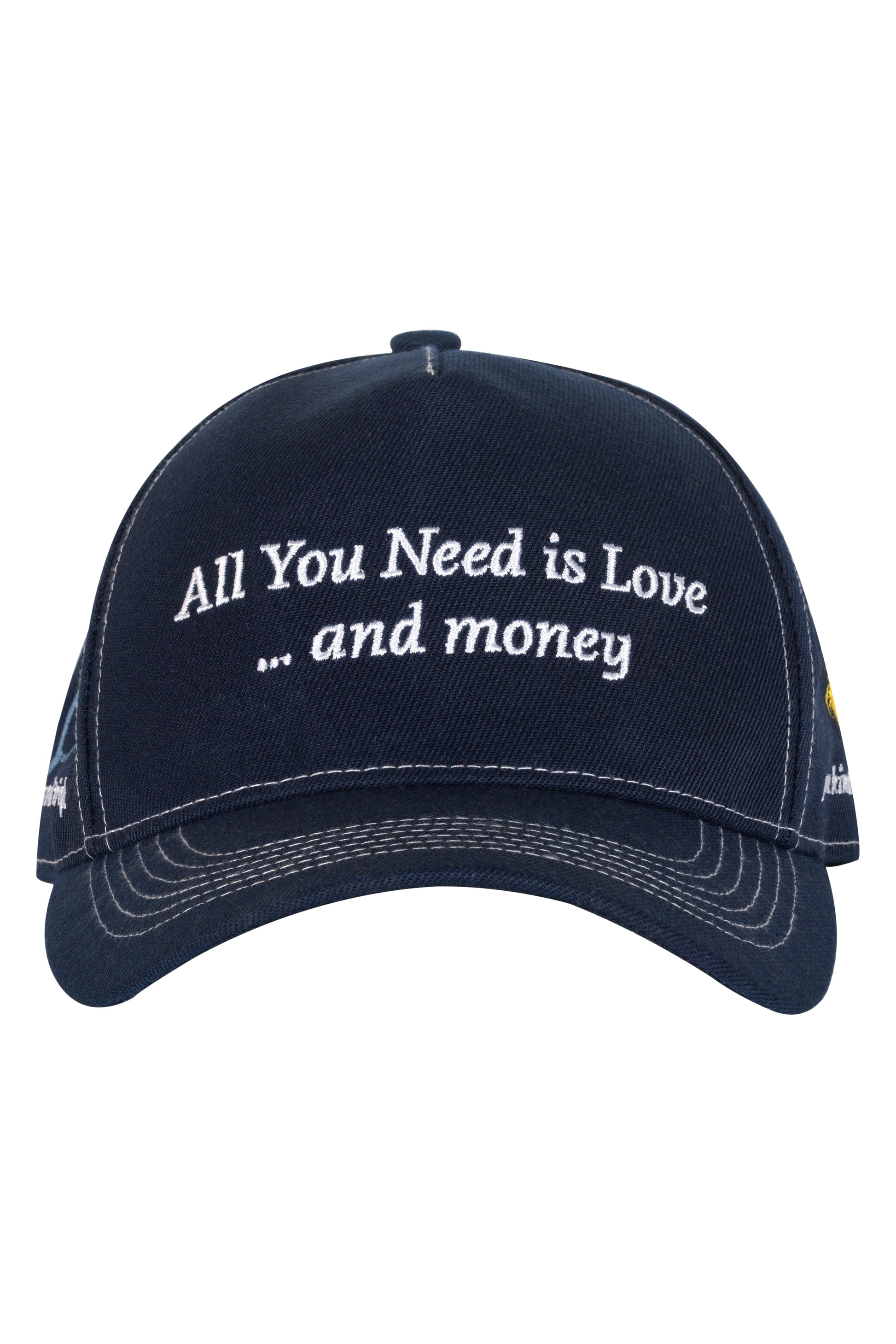 Navy blue cap embroidered with "All You Need is Love... and money" in white thread.