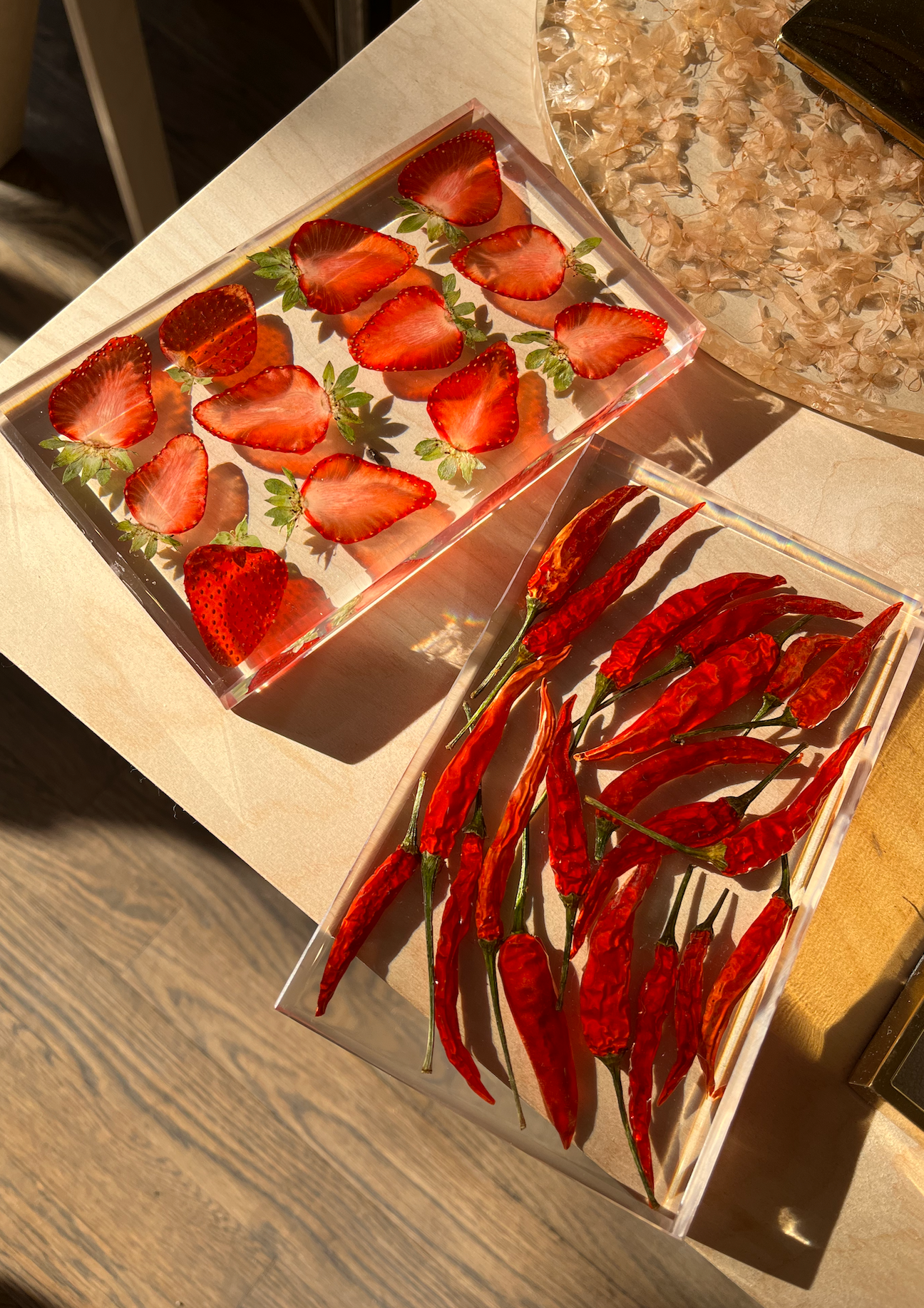 Strawberries sit suspended in a transparent resin tray. A durable-yet-whimsical addition to your home decor. Serve cocktails, use as a vanity tray, or simply display as an incredible objet d'art.