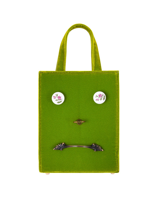 Chartreuse velvet bag with 4 metal and ceramic hardware  handles attached to the front of the bag.
