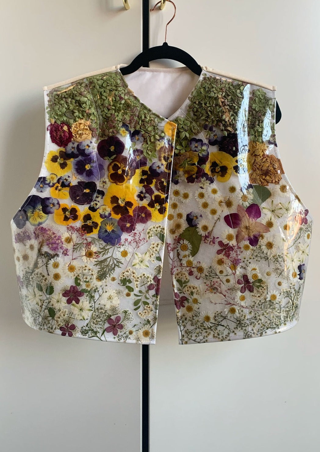 Puffer vest filled with approximately 1,000 real flowers-- everything from peonies to hydrangeas to pansies.