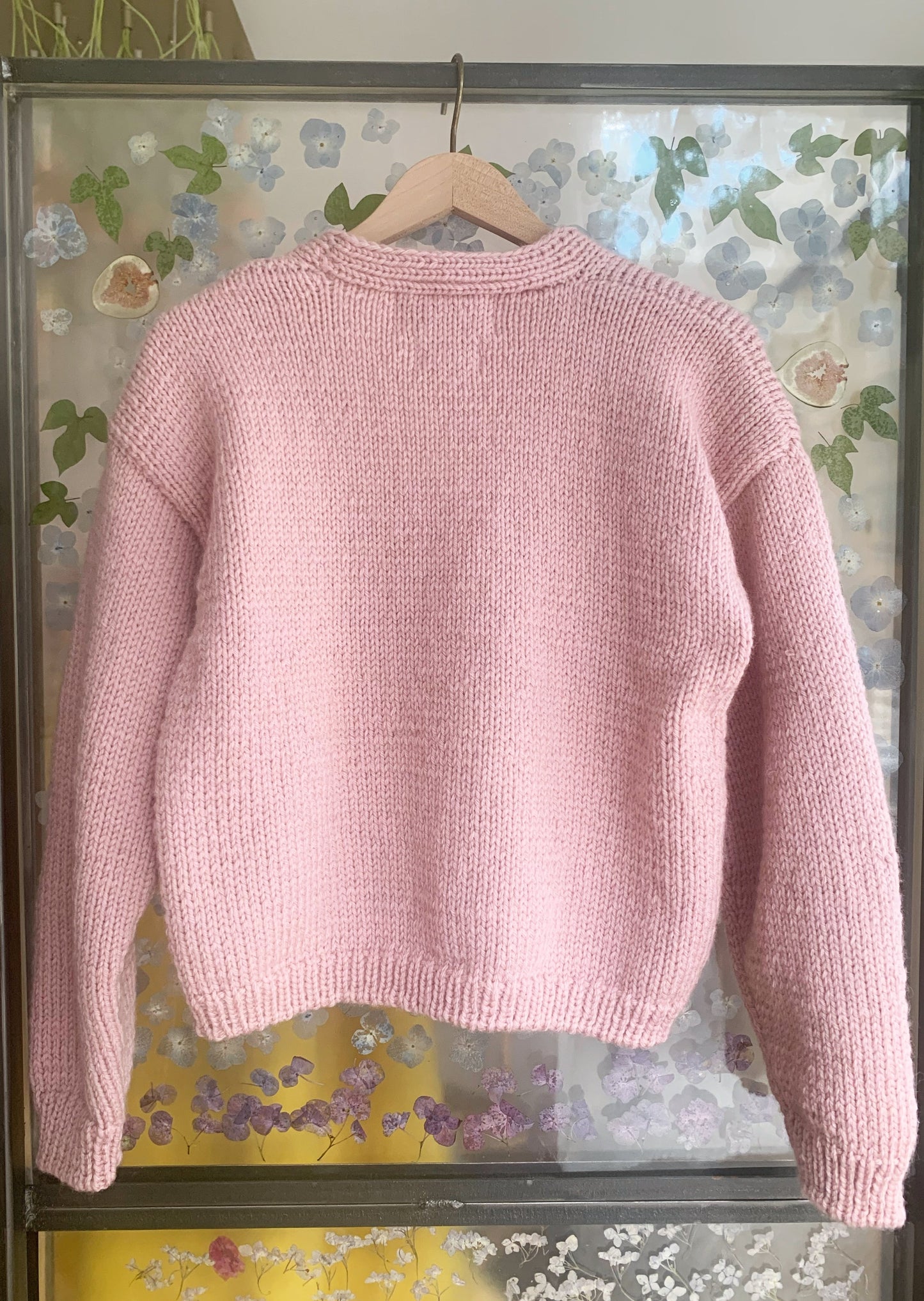 An exciting collaboration between designers Olivia Cheng and Lirika Matoshi, meet your new favorite pink cardigans outfitted with real preserved strawberry buttons. Slightly oversized fit. Deeply cozy and lovable.