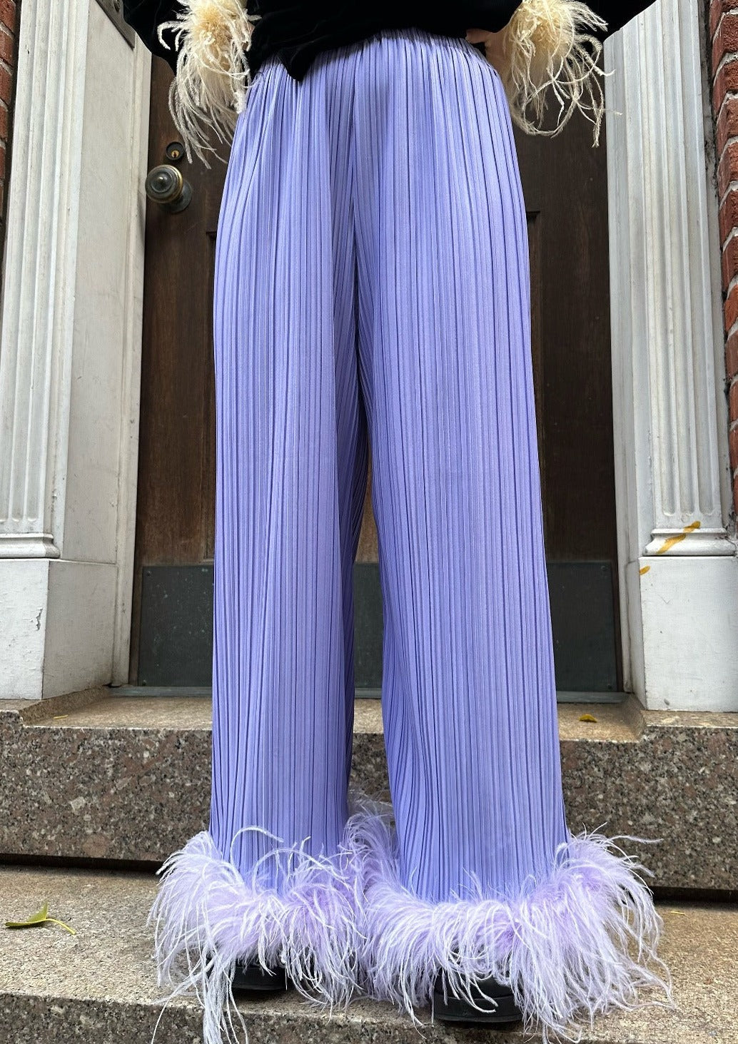 The perfect partner to your late night disco, these lilac swingy pleated high waist trousers are finished in a sweep of tonal lilac feathers.