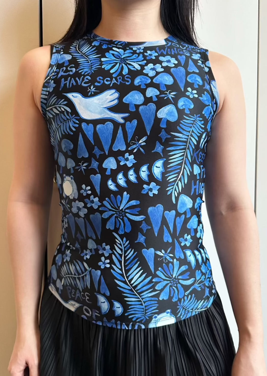 Printed recycled jersey sleeveless top in blue Lazy Boy Floral printed on black , water resistant fabric.