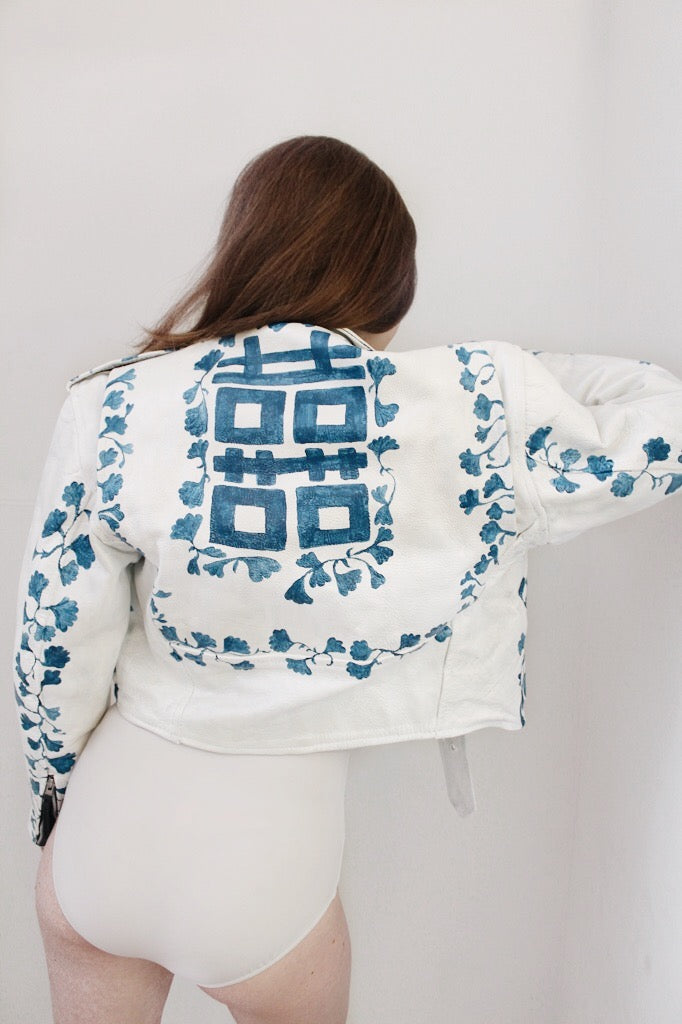 Vintage leather jacket, painted to look like an ancient blue and white vase, finished with pearlescent mica flakes for a three-dimensional sheen. 