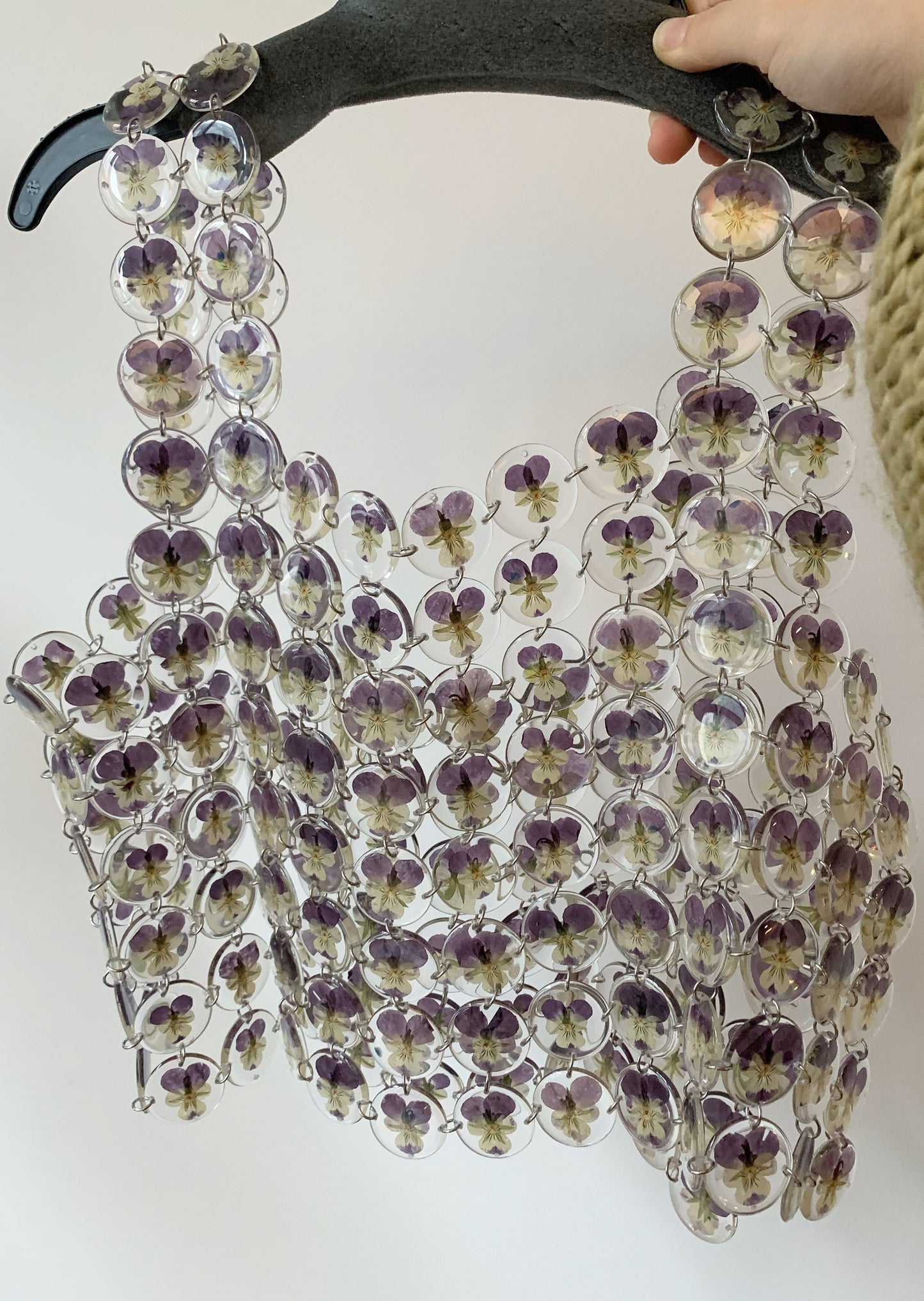 Chainmaille top made of pansies preserved in round resin charms connected by silver jump rings.