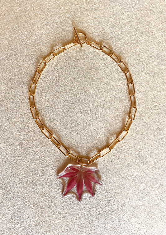 Resin dipped red Japanese maple leaf on gold chain necklace.