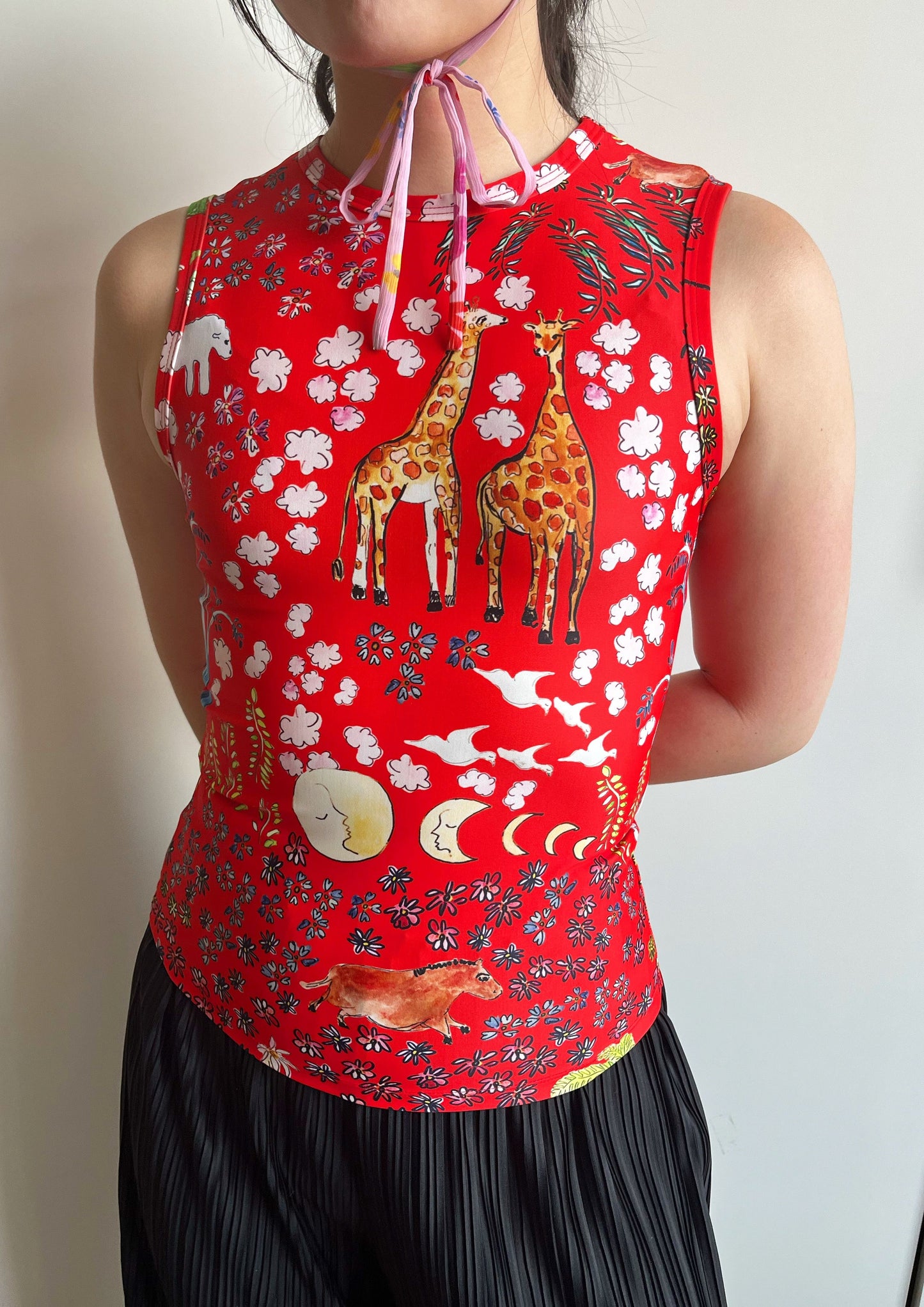 The platonically ideal high-cut tank top in our signature red Fever Dream print, a delightful smorgasbord of happy animals and botanicals. Made from a recycled polyester blend that is both anti-bacterial and moisture-resistant, meaning this top can also be worn as a swim top or rash guard.