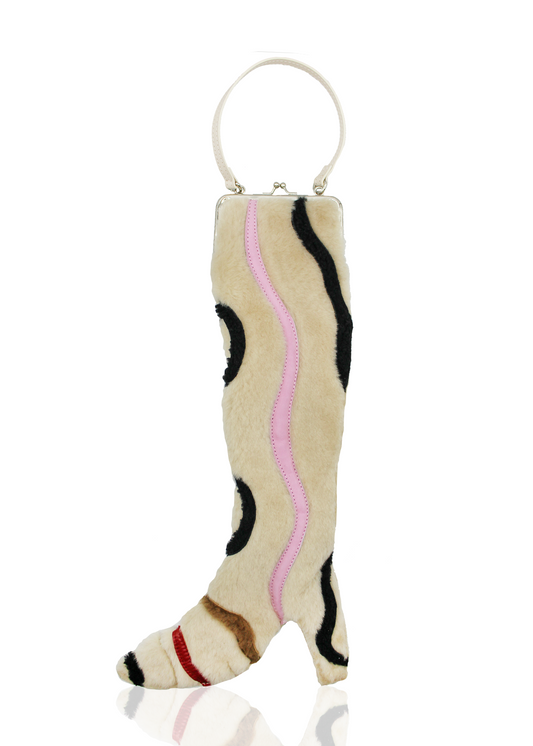 Cream shearling boot-shaped bag featuring whimsical patchworking in pink, black, brown, and red.