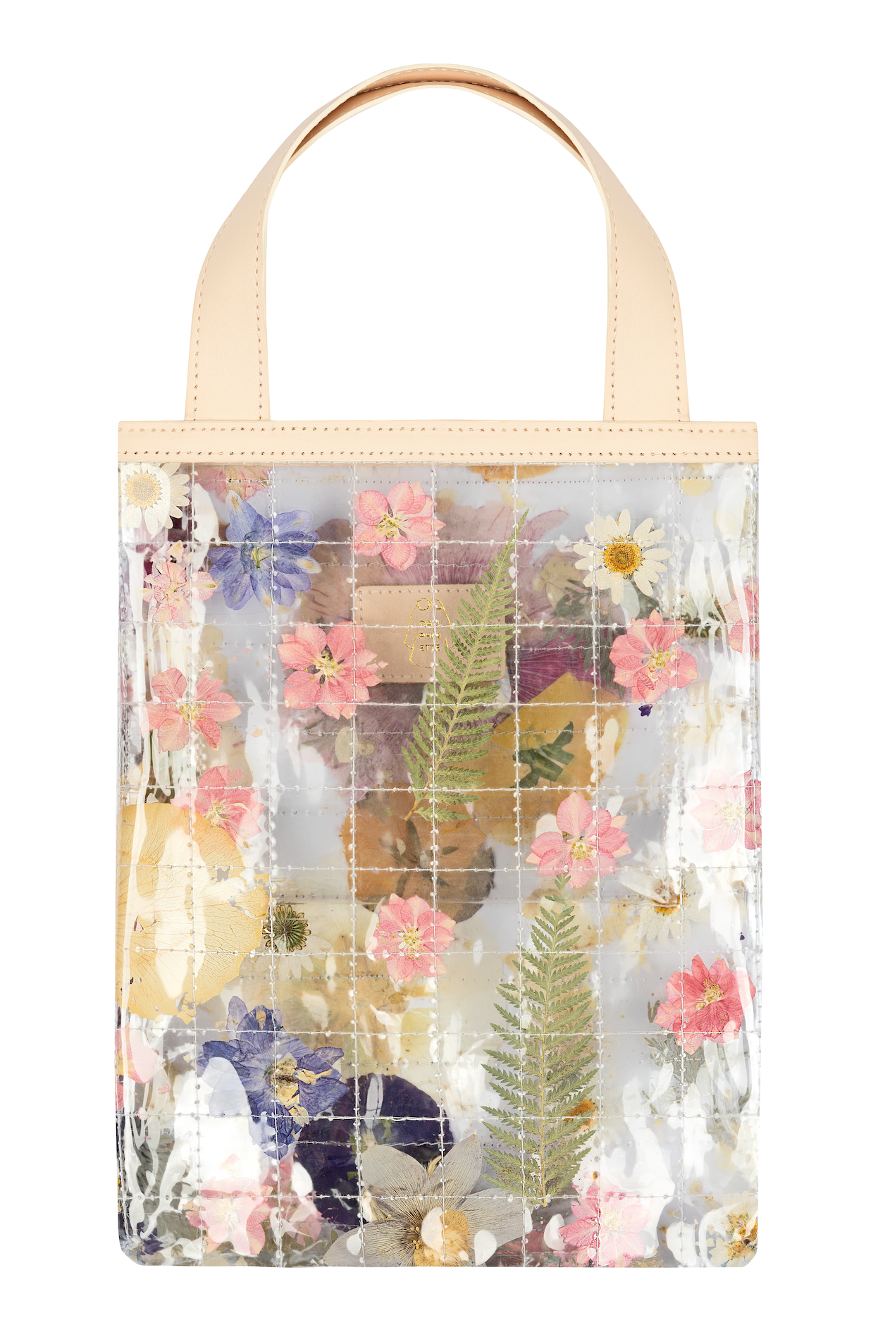 Clear quilted tote bag with dried leaves and flowers and cream straps.