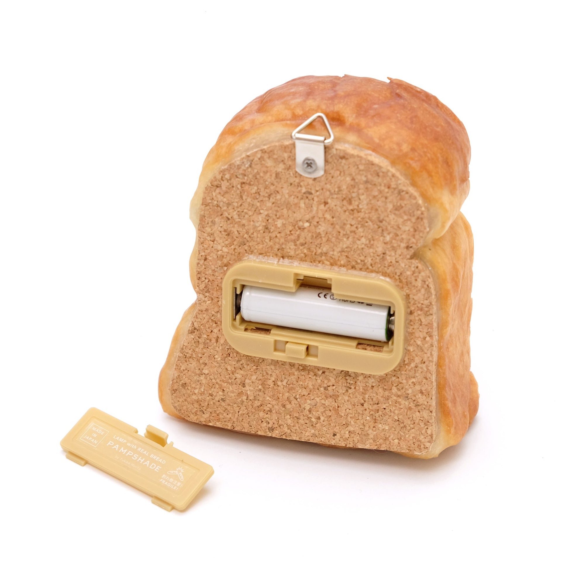 Cork Back of Bread lamp featuring a hook for hanging and a case for one battery