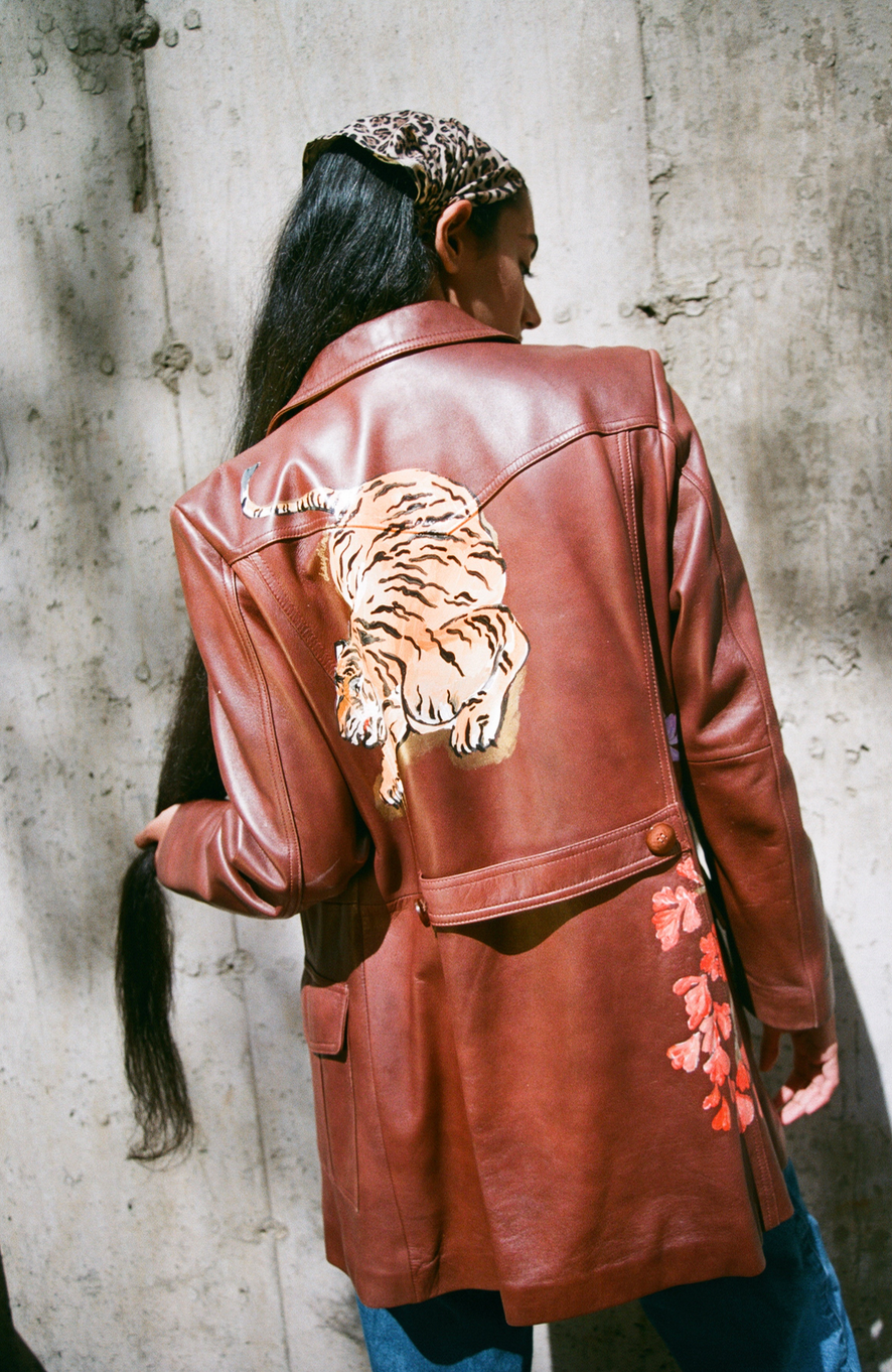 Hand-painted brown leather sportswear jacket from the 1980s. Tiger and floral motifs adapted from Chinese scroll paintings and cabinetry.