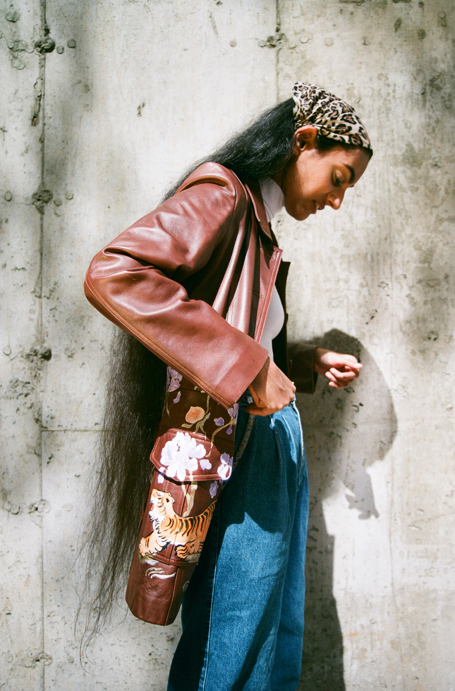 Hand-painted brown leather sportswear jacket from the 1980s. Tiger and floral motifs adapted from Chinese scroll paintings and cabinetry.