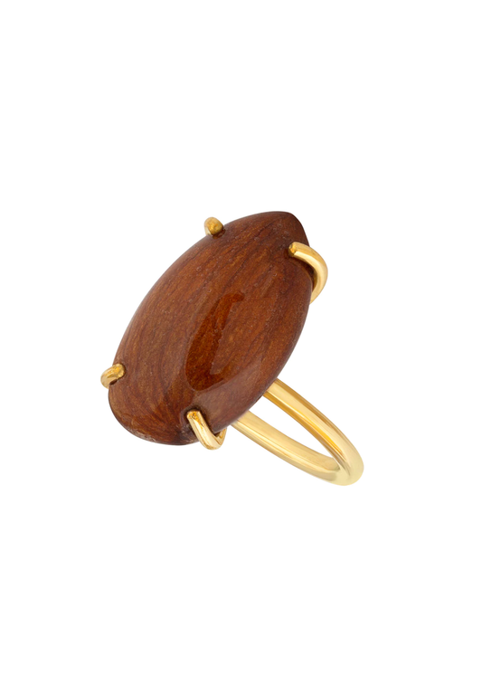 Almond preserved in resin on gold ring band.